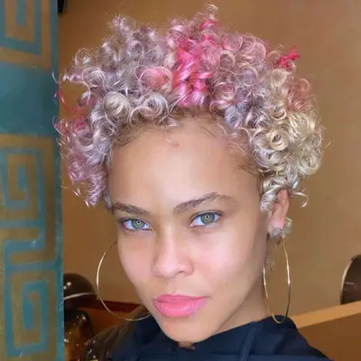 Woman with pink and blonde curly pixie cut