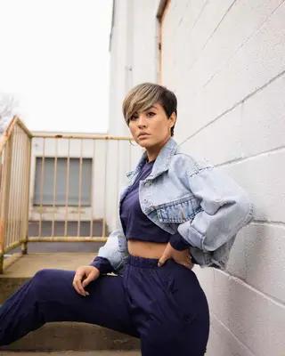 Woman with pixie cut with long bangs