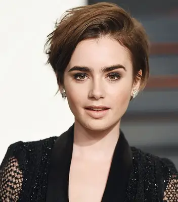 Lily Collins with a voluminous pixie cut with side part