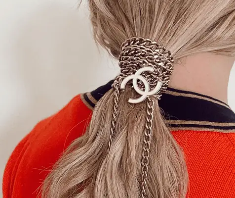 woman with chanel chains in ponytail