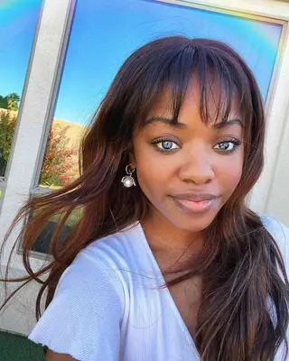 Person with wispy bangs and long beachy waves 