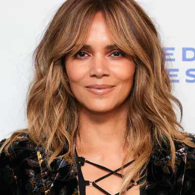 Halle Berry wears tousled, highlighted hair with bottleneck bangs