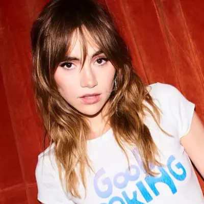 Suki Waterhouse wears a texturized, 