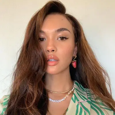 Music artist Isabella with tousled wavy hair and bronze highlights