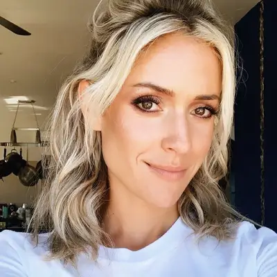 Kristin Cavallari wears half-up hair with bright blonde highlights