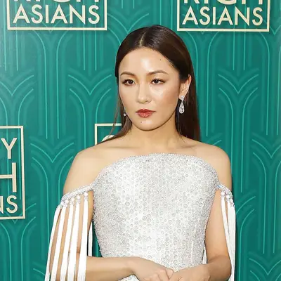 Constance Wu with a slicked-down, center-parted hairstyle at the 2018 
