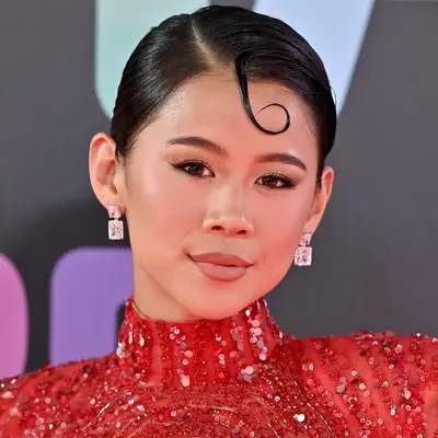 Leah Lewis with slicked-back hair and a deep side part at the 2023 