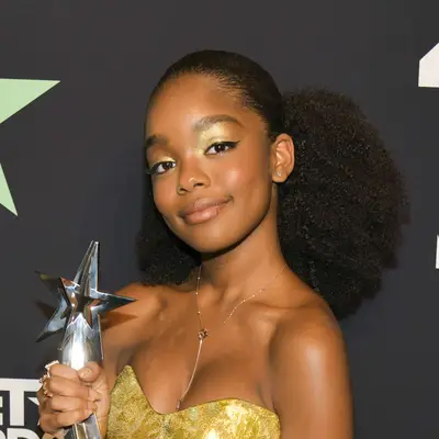 Marsai Martin wears a voluminous curly ponytail with slicked roots