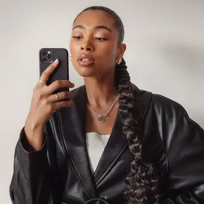 Creator with long ponytail braid with curly ends