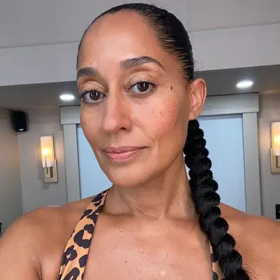 Tracee Ellis Ross wears a slicked back, twisted ponytail braid