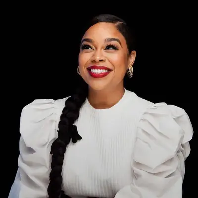 Julissa Calderon wears a side braided ponytail with ribbon