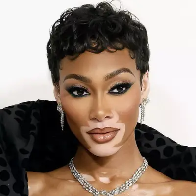Winnie Harlow with espresso brown curly pixie