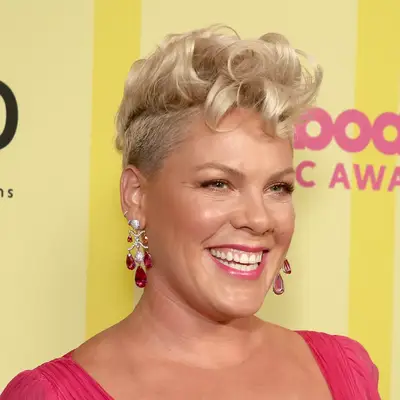 Pink with blonde, curly pompadour and pink outfit