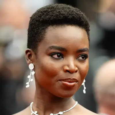 Maria Borges wears a buzz cut pixie in her natural hair texture to the Mad Max premiere 