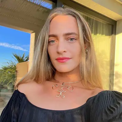 MYM Beauty editor Hallie Gould wears a dimensional linen blonde hair color and glossy pink lips