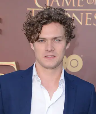 Actor Finn Jones with curly hair on the red carpet