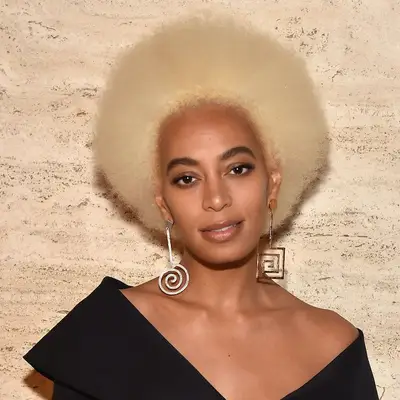 Solange wears a platinum blonde Afro hairstyle