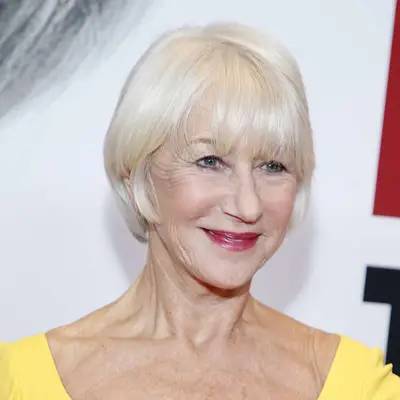 Helen Mirren with blunt bangs in yellow dress