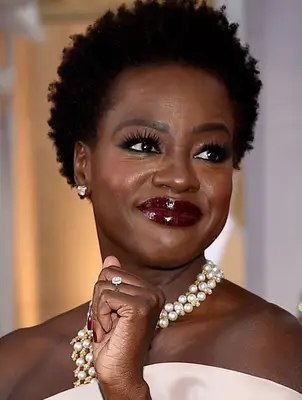 Viola Davis with short, curly hair and bold lip