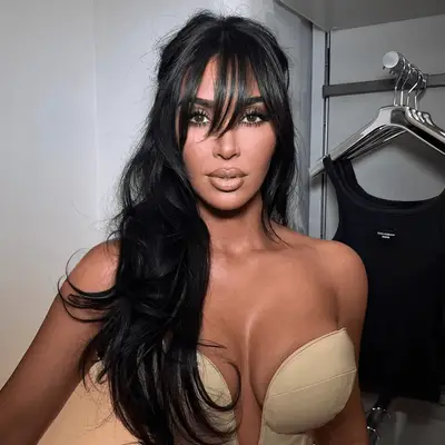 Victoria Beckham with long waves and curtain bangs