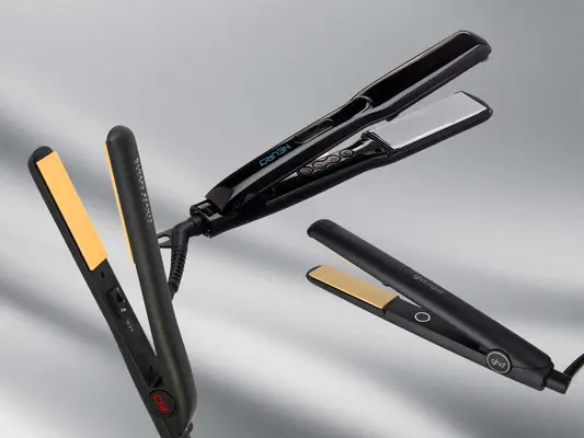 Collage of flat irons for natural hair, including CHI, Paul Mitchell, and ghd, on a gray background