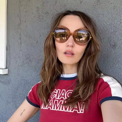 Chloe Fineman with brunette hair and big sunglasses