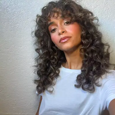 model with brown curly hair