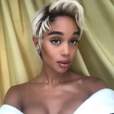 Laura Harrier wears a pixie cut with bleached ends