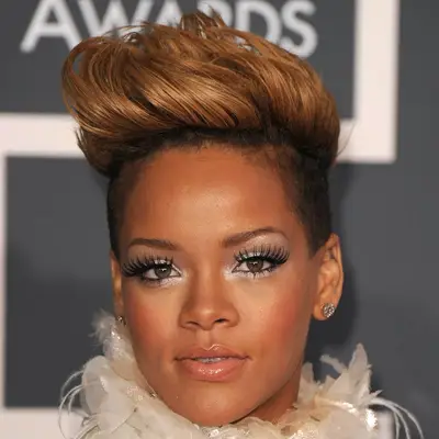 Rihanna wears a pompadour hairstyle with auburn ends