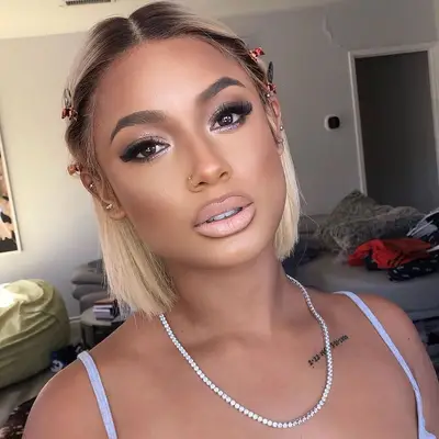 Woman with light blonde bob hairstyle with natural roots