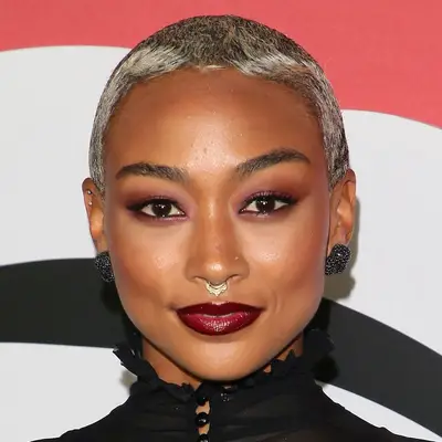 Tati Gabrielle wears a platinum pixie cut with dark roots