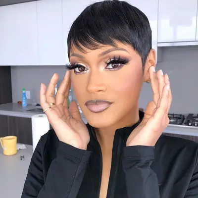 Woman with black pixie cut, lashes, and gradient lip