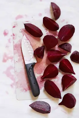 cut beets with knife on board