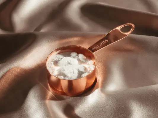 cup of baking soda on silk background