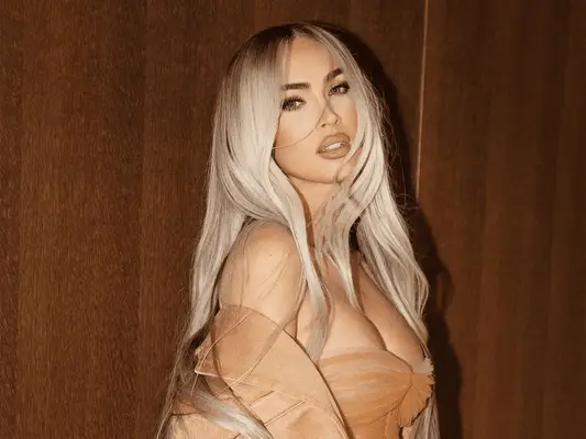 megan fox with blonde hair against wood background