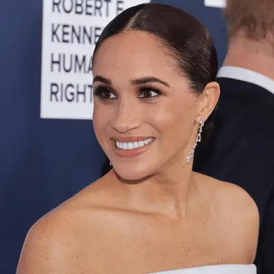 meghan markle wearing center part slick bun