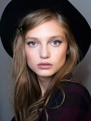 woman with blonde hair in black hat