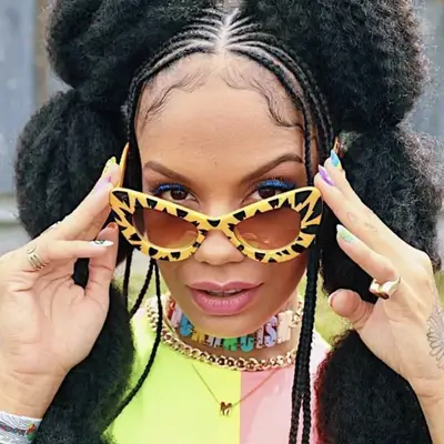 Woman with feed-in bubble braids and yellow animal print sunglasses