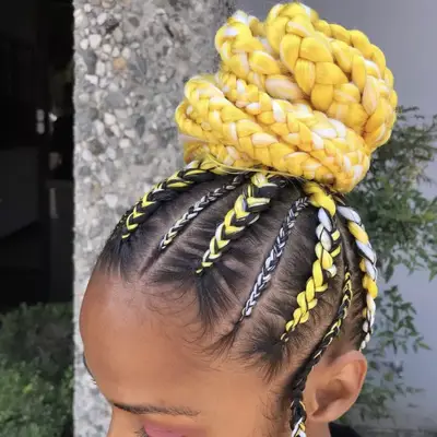 Woman with white and yellow feed-in braids in a high bun