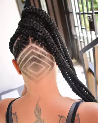 Woman with box braids and a geometric-styled undercut
