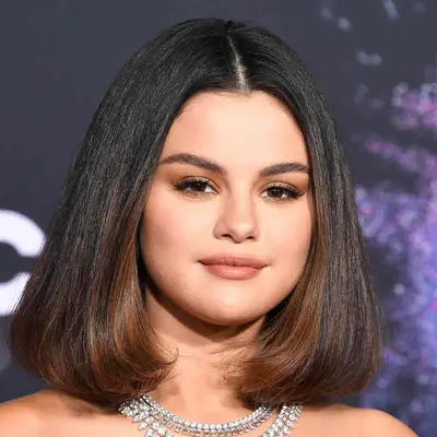 Selena Gomez wearing black bob with caramel highlights
