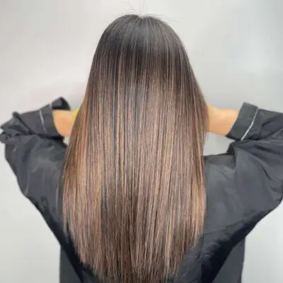 Woman with Brown hair with honey-brown highlights.