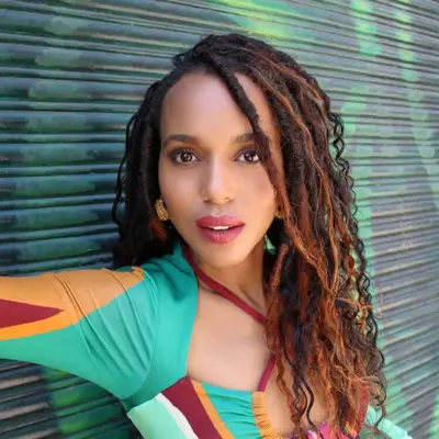 Kerry Washington wearing faux locs with brown balayage with copper tones.