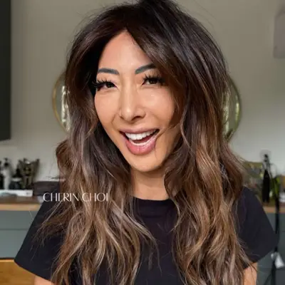Woman with brown hair with balayage.
