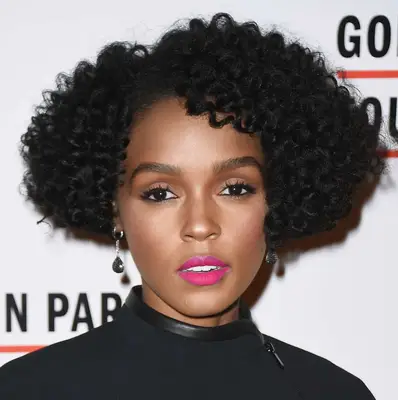 Janelle Monae attends an event with a curled micro bob and bright pink lip in NYC