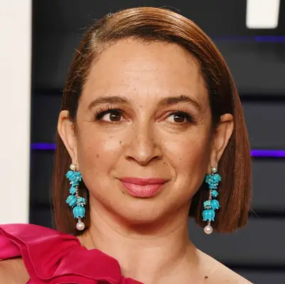 Maya Rudolph wears a straightened bob tucked behind her ears 