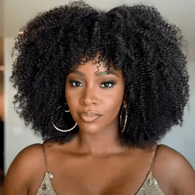 Teyonah Paris in naturally curly textured protective style wig