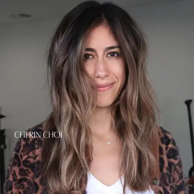 Woman with mushroom brown to mushroom blonde ombre hair