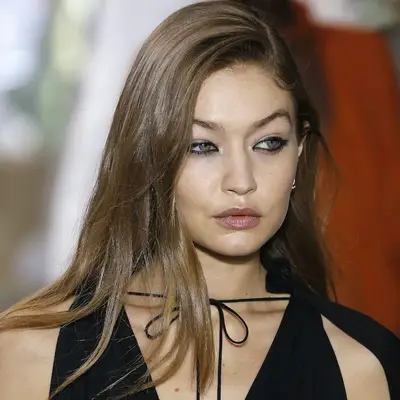 Gigi Hadid walks the runway with mushroom brown hair and black eyeliner