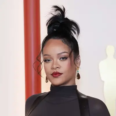 Rihanna attends the 95th Annual Academy Award in glam top knot and all-black outfit